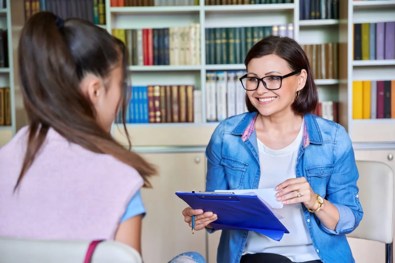 woman school psychologist teacher social worker mentor working with teenage girl 1